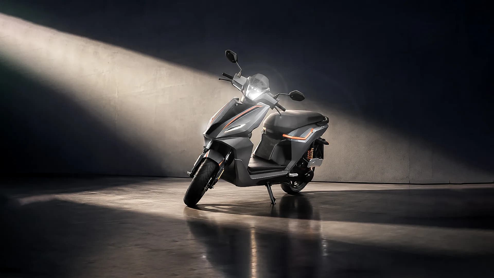 RIVOT NX100 scooter under a dramatic spotlight